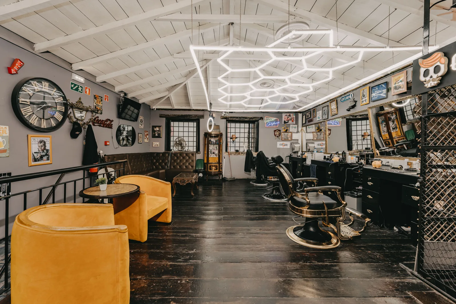 Classic Old Skull Rua dos Aranhas room with gold barber chairs and antique wood